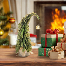 Load image into Gallery viewer, Decorative Grinch Christmas tree and gift boxes on a wooden table with a fireplace in the background.