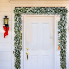 Load image into Gallery viewer, Decorative Christmas garland on a white door with a red bow and lantern.