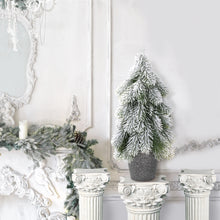 Load image into Gallery viewer, Decorative Christmas setting with a mantel, trees, and candles in a white room.