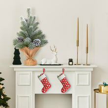 Load image into Gallery viewer, Decorative mantel with Christmas stockings, small tree, and candles on a white fireplace.