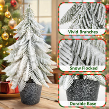 Load image into Gallery viewer, Decorative Christmas tree with snow-flocked branches and glittery base, surrounded by festive decorations.