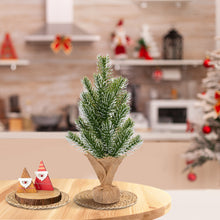 Load image into Gallery viewer, Small artificial Christmas tree on a table with decorative items in a kitchen setting.
