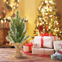 Load image into Gallery viewer, Small Christmas tree with wrapped gifts on a wooden table in front of a decorated Christmas tree.
